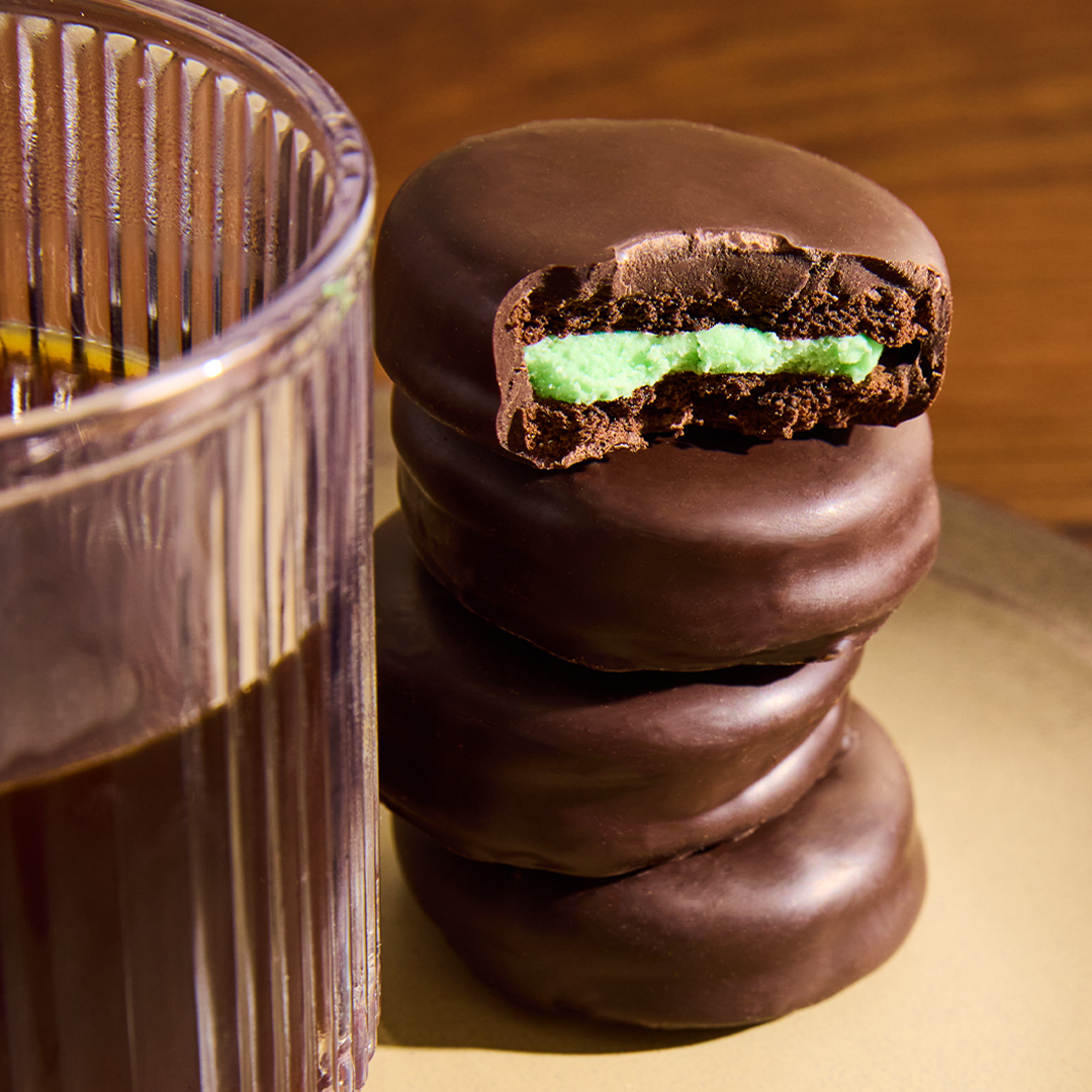 Stack of Puyallup Chocolates Dark Chocolate Mint Stack cookies next to a cup of coffee.